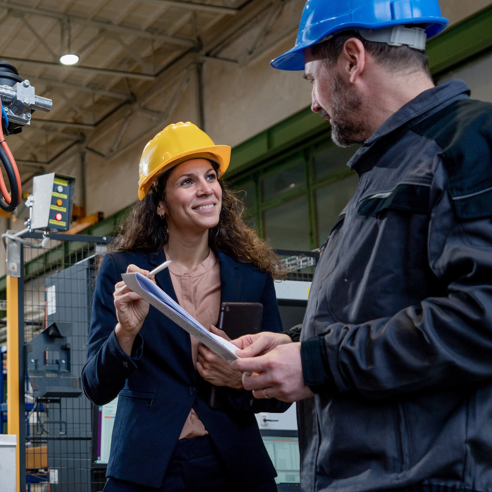 two warehouse employees discussing plans
