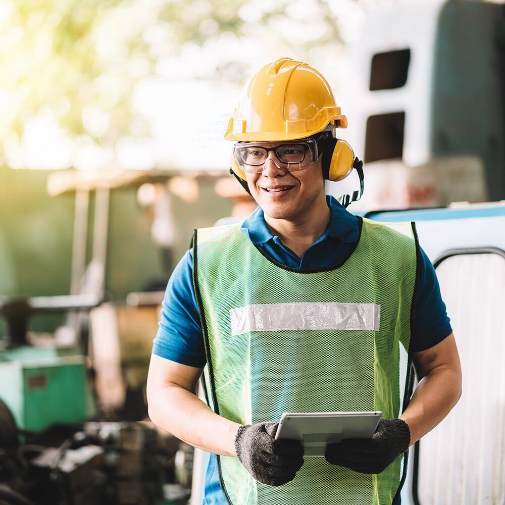 Metrology technician with a hard hat a high vis vest